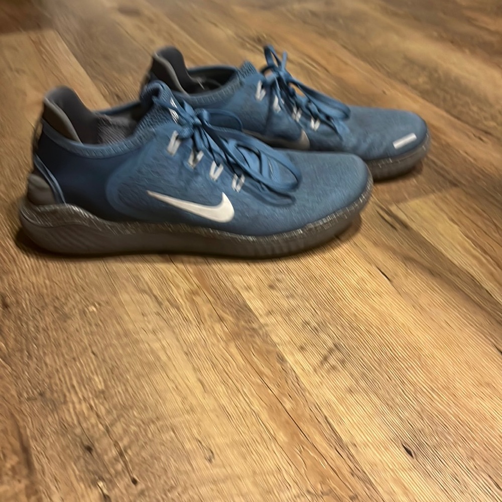 Used blue Nike-ID women’s running shoe, size 8.